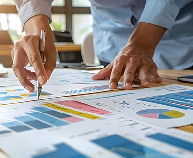 Businessperson doing process improvement analysis with charts on table.